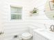Powder room with shiplap walls, modern fixtures, and a decorative shelf with greenery at 3139 Fairview Dr, Snellville, GA 30078