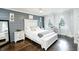 Stylish bedroom with a modern design, wood accent wall, and large windows with lots of natural light at 3139 Fairview Dr, Snellville, GA 30078