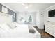 Bright bedroom features a desk, dark wood floors, and an accent wall with white curtains at 3139 Fairview Dr, Snellville, GA 30078