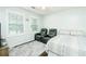 Light-filled bedroom with two recliners and a patterned rug and bedspread at 3139 Fairview Dr, Snellville, GA 30078