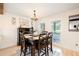 Formal dining room features wood table with seating for six, modern light fixture and ample natural light at 3139 Fairview Dr, Snellville, GA 30078