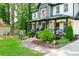 Inviting front porch with decorative trim, landscaped yard and a charming walkway leading to the entrance at 3139 Fairview Dr, Snellville, GA 30078