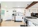 Open kitchen features stainless appliances, white cabinets, contrasting hardware, and marble countertops at 3139 Fairview Dr, Snellville, GA 30078