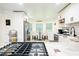 Stylish kitchen with stainless appliances, white cabinets, and a breakfast nook with natural lighting at 3139 Fairview Dr, Snellville, GA 30078