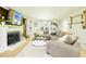 Comfortable living room featuring hardwood floors, a fireplace, built-in shelving, and ample seating at 3139 Fairview Dr, Snellville, GA 30078