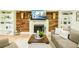 Cozy living room with hardwood floors, a fireplace with decorative mantle, and comfortable seating with stylish decor at 3139 Fairview Dr, Snellville, GA 30078