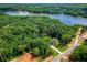 Stunning aerial view of the house nestled amidst a lush forest next to a beautiful lake at 410 Iroquois Ct, Covington, GA 30014