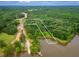 Aerial view highlighting the property's boundaries, proximity to the lake, and wooded surroundings at 410 Iroquois Ct, Covington, GA 30014