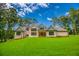New construction home with large windows overlooking the green lawn and landscaping at 410 Iroquois Ct, Covington, GA 30014