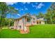 Spacious backyard featuring a new construction home with large windows overlooking the green lawn at 410 Iroquois Ct, Covington, GA 30014