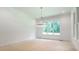 Bright dining room featuring modern lighting and large windows overlooking a lush green yard at 410 Iroquois Ct, Covington, GA 30014