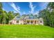 Charming home with a welcoming front porch, brick facade, well-manicured lawn, and professionally landscaped surroundings at 410 Iroquois Ct, Covington, GA 30014