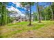 Expansive home exterior with a large yard, mature trees, and great natural light at 410 Iroquois Ct, Covington, GA 30014