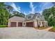 Spacious three-car garage with a long concrete driveway for ample parking at 410 Iroquois Ct, Covington, GA 30014