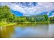 Beautiful lake view bordered by lush greenery, creating a serene and peaceful setting at 410 Iroquois Ct, Covington, GA 30014