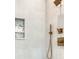 Modern shower with gray tiled walls, bronze fixtures, and a decorative inset shelf at 410 Iroquois Ct, Covington, GA 30014