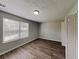Bright bedroom featuring wood-look floors, neutral walls, window with blinds and closet space at 155 Fairclift Dr, Covington, GA 30016
