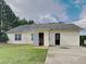 Back exterior view showing the home with siding, a yard, and a partial concrete patio at 155 Fairclift Dr, Covington, GA 30016