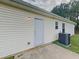 Back exterior view featuring siding, a door, and a gray air conditioning unit on a concrete patio at 155 Fairclift Dr, Covington, GA 30016