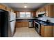 Kitchen featuring stainless steel appliances, wood cabinets, and a double sink at 155 Fairclift Dr, Covington, GA 30016