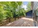 Large wooden deck with intricate railing offers a private outdoor space surrounded by lush greenery at 178 Castleair Ne Dr, Kennesaw, GA 30144