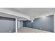 Partially finished basement with painted concrete walls, drop ceiling, and closet at 178 Castleair Ne Dr, Kennesaw, GA 30144