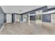 Large basement features tile floors, neutral paint, access to laundry, and glass doors to the yard at 178 Castleair Ne Dr, Kennesaw, GA 30144