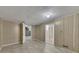 Partially finished basement with tile floors, wood paneling, and access to other rooms at 178 Castleair Ne Dr, Kennesaw, GA 30144