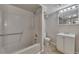 Well-lit basement bathroom featuring a combined shower-tub, toilet, and vanity with overhead lighting at 178 Castleair Ne Dr, Kennesaw, GA 30144