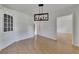 Dining room featuring hardwood floors, built in cabinet, bright windows and a modern light fixture at 178 Castleair Ne Dr, Kennesaw, GA 30144