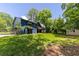 Exterior view of home with fenced yard, shed, and a multi-level deck surrounded by mature trees at 178 Castleair Ne Dr, Kennesaw, GA 30144