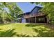 Exterior view with expansive backyard, multi-level deck, and a lush green lawn at 178 Castleair Ne Dr, Kennesaw, GA 30144