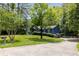 Charming blue house with a red door and a well-manicured lawn at 178 Castleair Ne Dr, Kennesaw, GA 30144