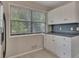 Kitchen offers ample cabinet space and a large window with natural light at 178 Castleair Ne Dr, Kennesaw, GA 30144