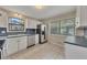 Cozy kitchen with white cabinets, stainless steel appliances, tile floors and plenty of natural light at 178 Castleair Ne Dr, Kennesaw, GA 30144
