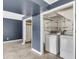 Bright laundry area with washer, dryer, shelving, and access to additional storage at 178 Castleair Ne Dr, Kennesaw, GA 30144