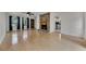 Open-concept living room with hardwood floors, fireplace, ceiling fan, and access to the kitchen and outdoor deck at 178 Castleair Ne Dr, Kennesaw, GA 30144