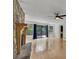 Bright living room with hardwood floors, stone fireplace, ceiling fan and large sliding doors to the deck at 178 Castleair Ne Dr, Kennesaw, GA 30144