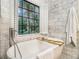 Elegant bathroom with soaking tub, natural light, and neutral tones for a relaxing spa ambiance at 1833 N Rock Springs Ne Rd, Atlanta, GA 30324