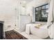 Bright bathroom features a soaking tub, glass-enclosed shower, and modern fixtures and finishes at 1833 N Rock Springs Ne Rd, Atlanta, GA 30324