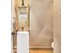 Stylish powder room features a pedestal sink, gold-framed mirror, and unique textured wallpaper at 1833 N Rock Springs Ne Rd, Atlanta, GA 30324