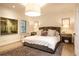 Serene bedroom features neutral tones, a plush bed, and abundant natural light from the window at 1833 N Rock Springs Ne Rd, Atlanta, GA 30324