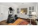 Bright exercise room features a modern elliptical machine, shuttered windows, and elegant hardwood floors at 1833 N Rock Springs Ne Rd, Atlanta, GA 30324