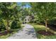 Charming home featuring an elongated driveway with mature trees and well-manicured landscaping at 1833 N Rock Springs Ne Rd, Atlanta, GA 30324