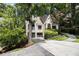 Lovely painted-brick home with well-kept landscaping and a two-car garage on a sunny day at 1833 N Rock Springs Ne Rd, Atlanta, GA 30324