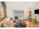 Elegant living room with hardwood floors, neutral decor, and natural light from shuttered windows at 1833 N Rock Springs Ne Rd, Atlanta, GA 30324