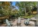 Inviting backyard with brick patio, fire pit, Adirondack chairs, and beautiful landscaping at 1833 N Rock Springs Ne Rd, Atlanta, GA 30324