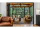 Inviting sunroom with wood beams, comfortable seating, and screened windows to view lush landscaping at 1833 N Rock Springs Ne Rd, Atlanta, GA 30324
