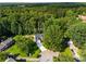 Overhead view of the home surrounded by mature trees and lush greenery at 4140 Camaron Way, Snellville, GA 30039