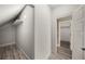 Attic storage space with slanted ceilings and hardwood floors, with access to closet space at 4140 Camaron Way, Snellville, GA 30039